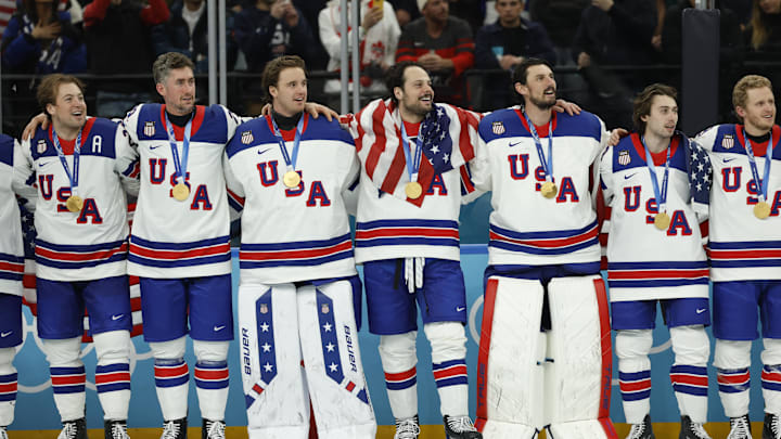 Feb 22, 2026; Milan, Italy; United States players including Auston Matthews (34) of the United States and Connor Hellebuyck (37) of the United States celebrate with their gold medals after defeating Canada in the men's ice hockey gold medal game during the Milano Cortina 2026 Olympic Winter Games at Milano Santagiulia Ice Hockey Arena. Mandatory Credit: Geoff Burke-Imagn Images Feb 22, 2026; Milan, Italy; United States players including Auston Matthews (34) of the United States and Connor Hellebuyck (37) of the United States celebrate with their gold medals after defeating Canada in the men's ice hockey gold medal game during the Milano Cortina 2026 Olympic Winter Games at Milano Santagiulia Ice Hockey Arena. Mandatory Credit: Geoff Burke-Imagn Images