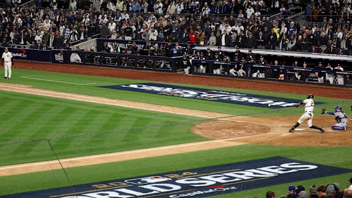 Oct 28, 2024; New York, New York, USA; New York Yankees designated hitter Giancarlo Stanton (27) singles during the sixth inning against the Los Angeles Dodgers in game three of the 2024 MLB World Series at Yankee Stadium. Mandatory Credit: Vincent Carchietta-Imagn Images