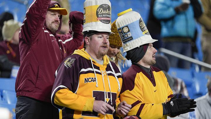 Jan 3, 2025; Charlotte, NC, USA;  Minnesota Golden Gophers fans wearing their Dukes hats during the second half against the Virginia Tech Hokies at the Duke’s Mayo Bowl at Bank of America Stadium. Mandatory Credit: Jim Dedmon-Imagn Images