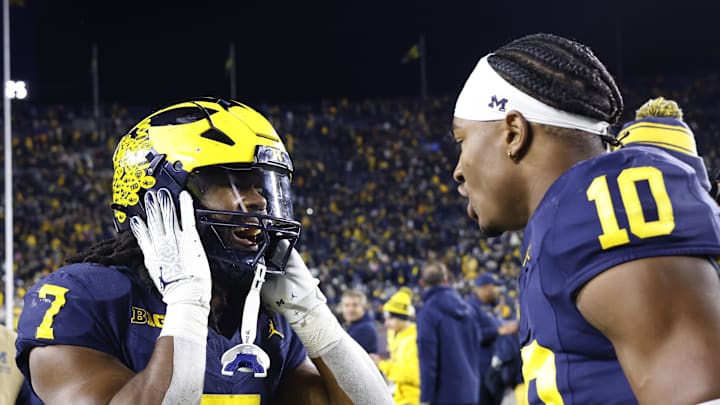 Oct 26, 2024; Ann Arbor, Michigan, USA;  Michigan Wolverines running back Donovan Edwards (7) and  quarterback Alex Orji (10) celebrate after defeating the Michigan State Spartans at Michigan Stadium. Mandatory Credit: Rick Osentoski-Imagn Images