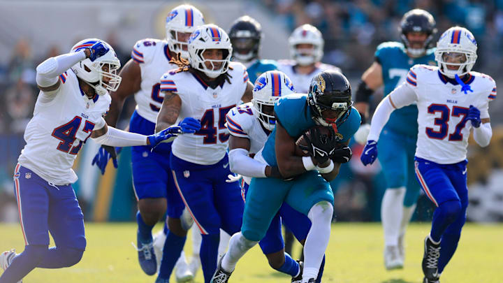 Jacksonville Jaguars running back Travis Etienne Jr. (1) is tackled by Buffalo Bills cornerback Tre'davious White (27) during the third quarter of an NFL football AFC Wild Card playoff matchup, Sunday, Jan. 11, 2026, in Jacksonville, Fla. The Bills defeated the Jaguars 27-24. [Corey Perrine/Florida Times-Union] 