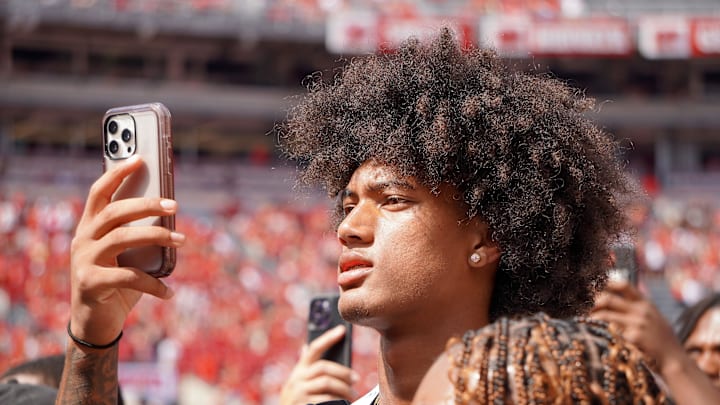 Aug 31, 2024; Columbus, OH, USA; Mater Dei wide receiver Chris Henry Jr. films as Ohio State football warms up before the Buckeyes' 52-6 win over Akron.