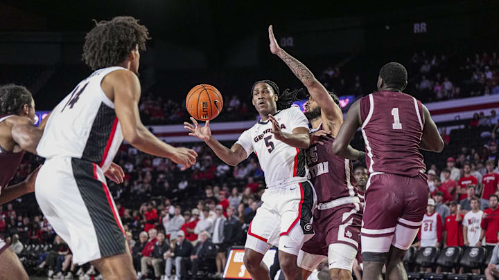 Nov 10, 2024; Athens, Georgia, USA; Georgia Bulldogs guard Silas Demary Jr. (5) passes there ball to forward Asa Newell (14) against Texas Southern Tigers forward Grayson Carter (25) during the first half at Stegeman Coliseum. Mandatory Credit: Dale Zanine-Imagn Images
