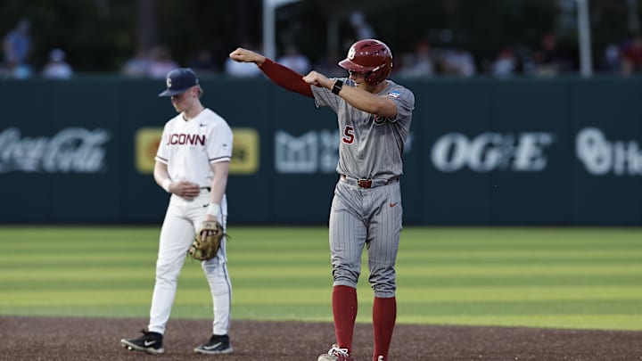 Jun 1, 2024; Norman, OK, USA; Oklahoma Sooners infielder Michael Snyder (5) gestures after advancing to second base during the second inning of an NCAA Division I Baseball Championship game between the UConn Huskies and the Oklahoma Sooners at L. Dale Mitchell Park. Credit: Alonzo Adams-USA TODAY Sports