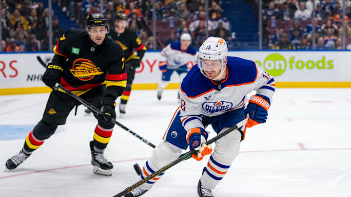Vancouver Canucks defenseman Carson Soucy (7) watches Edmonton Oilers forward Zach Hyman (18)