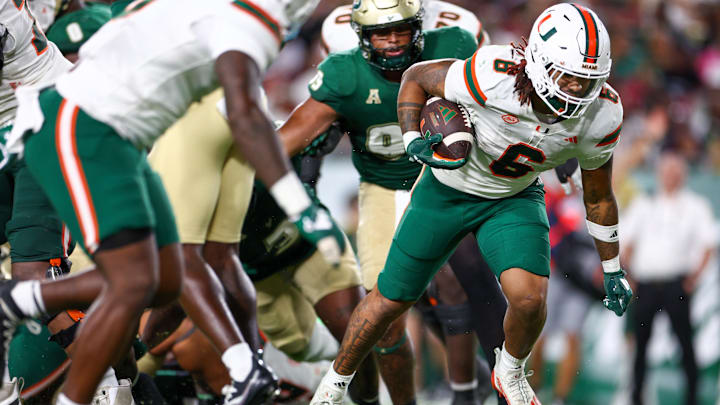 Sep 21, 2024; Tampa, Florida, USA; Miami Hurricanes running back Damien Martinez (6) scores a touchdown against the South Florida Bulls in the third quarter at Raymond James Stadium. Mandatory Credit: Nathan Ray Seebeck-Imagn Images