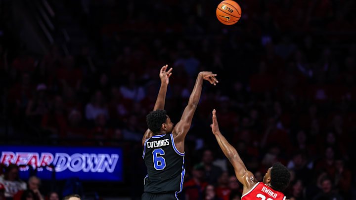 Feb 22, 2025; Tucson, Arizona, USA; BYU Cougars forward Kanon Catchings (6) shoots a three-point shot over Arizona Wildcats forward Tobe Awaka (30) during the second half at McKale Center. Mandatory Credit: Aryanna Frank-Imagn Images