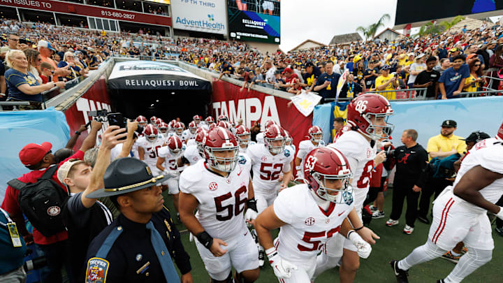 Dec 31, 2024; Tampa, FL, USA; Alabama Crimson Tide linebacker Vito Perri (53) and Alabama Crimson Tide punter James Burnip (86) lead the team onto the field before a game against the Michigan Wolverines at Raymond James Stadium. Mandatory Credit: Matt Pendleton-Imagn Images