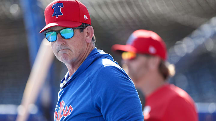 Philadelphia Phillies manager Rob Thomson (59) directs batting practice before a game against the New York Yankees at BayCare Ballpark.