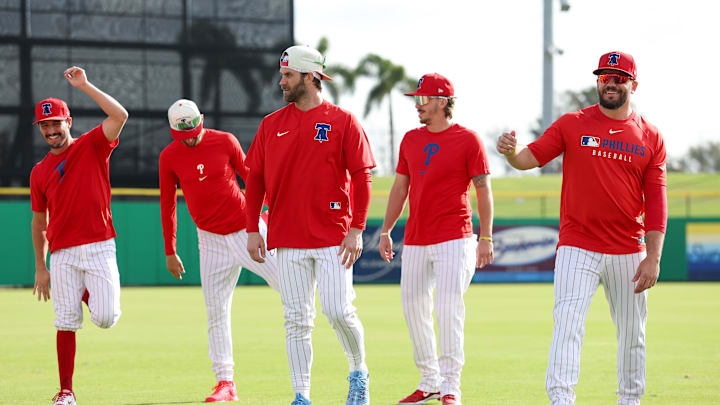 Feb 19, 2025; Clearwater, FL, USA; Philadelphia Phillies catcher Garrett Stubbs (21) (left) shortstop Trea Turner (7) (left center) first base Bryce Harper (3) (left center) second base Bryson Stott (5) (right center) and designated hitter Kyle Schwarber (12) (right) participate in spring training workouts at BayCare Ballpark. Mandatory Credit: Nathan Ray Seebeck-Imagn Images
