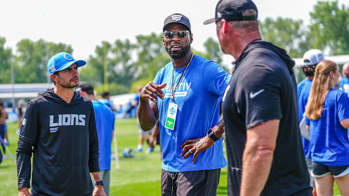 Detroit Lions former WR Calvin Johnson talks with head coach Dan Campbell at the end of the joint practice with the Miami Dolphins at the Lions headquarters and training facility in Allen Park, Thursday, Aug. 14 2025