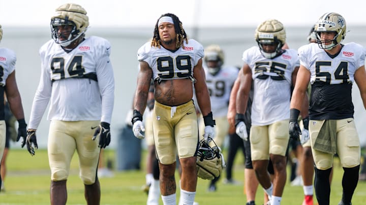 Jul 30, 2025; New Orleans, LA, USA;  New Orleans Saints defensive end Chase Young (99) and defensive end Jonah Williams (54) look on during training camp at Ochsner Sports Performance Center. Mandatory Credit: Stephen Lew-Imagn Images