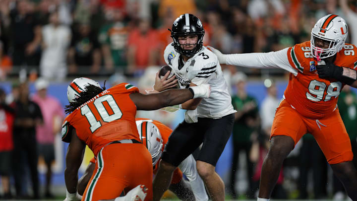 aDec 28, 2024; Orlando, FL, USA; Iowa State Cyclones quarterback Rocco Becht (3) is pressured by Miami Hurricanes defensive lineman Simeon Barrow Jr. (10) in the fourth quarter during the Pop Tarts bowl at Camping World Stadium. Mandatory Credit: Nathan Ray Seebeck-Imagn Images