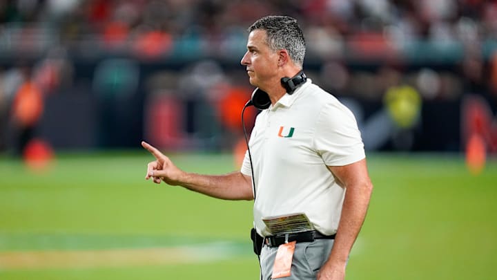Nov 8, 2025; Miami Gardens, Florida, USA; Miami Hurricanes head coach Mario Cristobal gives his team instructions against the Syracuse Orange during the third quarter at Hard Rock Stadium. Mandatory Credit: Jeff Romance-Imagn Images