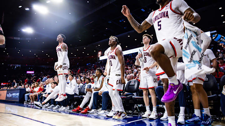 Dec 21, 2024; Tucson, Arizona, USA; Arizona Wildcats guard Caleb Love (1) and guard Jaden Bradley (0) stand up in excitement during the second half of the game against the Central Michigan Chippewas at McKale Center. Mandatory Credit: Aryanna Frank-Imagn Images