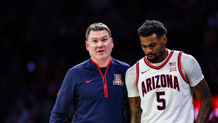 Jan 11, 2025; Tucson, Arizona, USA; Arizona Wildcats head coach Tommy Lloyd talks with guard KJ Lewis (5) during the first half against the UCF Knights at McKale Center. Mandatory Credit: Aryanna Frank-Imagn Images