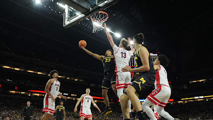 Apr 4, 2026; Indianapolis, IN, USA; Michigan Wolverines forward Yaxel Lendeborg (23) shoots against Arizona Wildcats center Motiejus Krivas (13) in the first half during a semifinal of the Final Four of the men's 2026 NCAA Tournament at Lucas Oil Stadium. Mandatory Credit: Robert Deutsch-Imagn Images