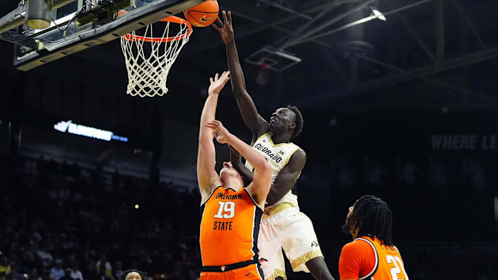 Feb 21, 2026; Boulder, Colorado, USA; Colorado Buffaloes forward Bangot Dak (8) shoots the ball over Oklahoma State Cowboys forward Andrija Vukovic (19) in the second half at the CU Events Center. Mandatory Credit: Ron Chenoy-Imagn Images