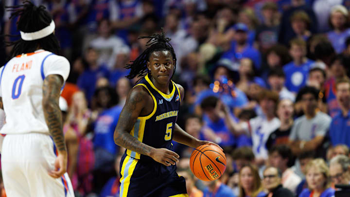 Nov 21, 2025; Gainesville, Florida, USA; Merrimack Warriors guard Kevair Kennedy (5) dribbles the ball at Florida Gators guard Boogie Fland (0) during the first half at Exactech Arena at the Stephen C. O'Connell Center. Mandatory Credit: Matt Pendleton-Imagn Images