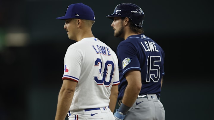 Jul 19, 2023; Arlington, Texas, USA; Texas Rangers first baseman Nathaniel Lowe (30) and Tampa Bay Rays designated hitter Josh Lowe (15) stand on the field in the fourth inning at Globe Life Field. Mandatory Credit: Tim Heitman-Imagn Images