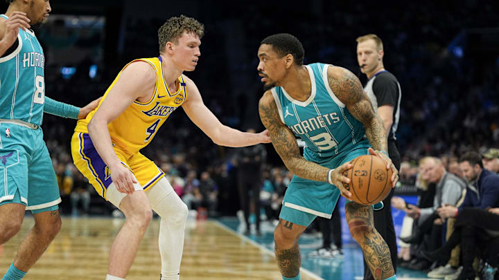 Jan 27, 2025; Charlotte, North Carolina, USA; Charlotte Hornets guard DaQuan Jeffries (3) handles the ball against Los Angeles Lakers guard Dalton Knecht (4) during the second half at the Spectrum Center. Mandatory Credit: Jim Dedmon-Imagn Images