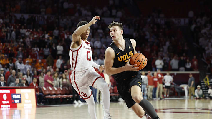 Feb 8, 2025; Norman, Oklahoma, USA; Tennessee Volunteers forward Igor Milicic Jr. (7) drives around Oklahoma Sooners guard Jeremiah Fears (0) during the first half at Lloyd Noble Center. Mandatory Credit: Alonzo Adams-Imagn Images