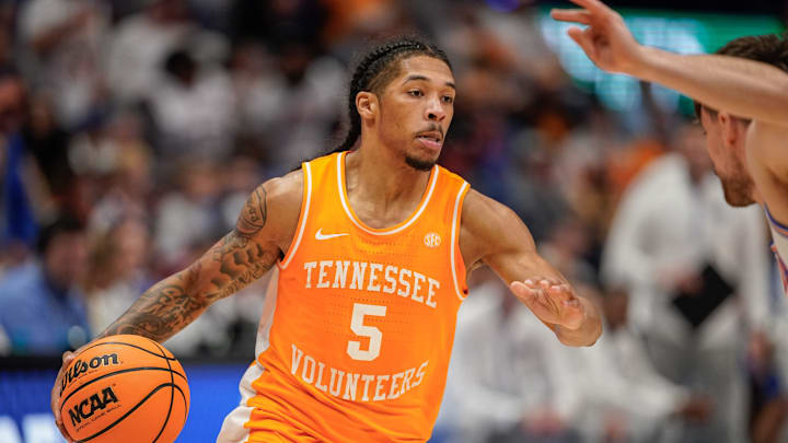 Tennessee guard Zakai Zeigler (5) looks for a path around Florida defenders during the second half of the Southeastern Conference tournament championship at Bridgestone Arena in Nashville, Tenn., Sunday, March 16, 2025.