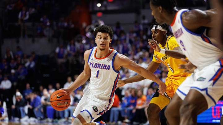 Jan 14, 2025; Gainesville, Florida, USA; Florida Gators guard Walter Clayton Jr. (1) drives to the basket past Missouri Tigers guard Anthony Robinson II (0) during the second half at Exactech Arena at the Stephen C. O'Connell Center. Mandatory Credit: Matt Pendleton-Imagn Images