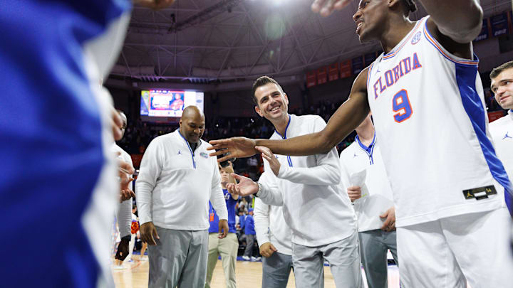 Jan 25, 2025; Gainesville, Florida, USA; Florida Gators head coach Todd Golden smiles in the huddle with Florida Gators center Rueben Chinyelu (9) after a game against the Georgia Bulldogs at Exactech Arena at the Stephen C. O'Connell Center. Mandatory Credit: Matt Pendleton-Imagn Images