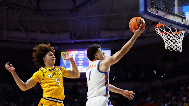Jan 14, 2025; Gainesville, Florida, USA; Florida Gators guard Walter Clayton Jr. (1) makes a layup over Missouri Tigers guard T.O. Barrett (5) during the second half at Exactech Arena at the Stephen C. O'Connell Center. Mandatory Credit: Matt Pendleton-Imagn Images