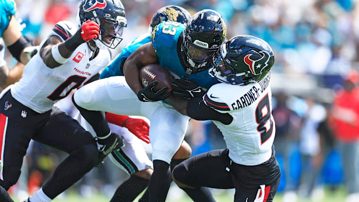 Jacksonville Jaguars running back Bhayshul Tuten (33) is tackled by Houston Texans safety CJ. Gardner-Johnson (8) during the second quarter of an NFL football matchup at EverBank Stadium, Sunday, Sept. 21, 2025, in Jacksonville, Fla. The Jaguars defeated the Texans 17-10. The Jaguars defeated the Texans 17-10.