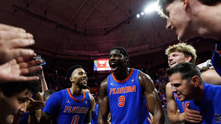 Jan 10, 2026; Gainesville, Florida, USA; Florida Gators guard Boogie Fland (0), Florida Gators center Rueben Chinyelu (9)  forward Thomas Haugh (10) and head coach Todd Golden celebrate after a game against the Tennessee Volunteers at Exactech Arena at the Stephen C. O'Connell Center. Mandatory Credit: Matt Pendleton-Imagn Images
