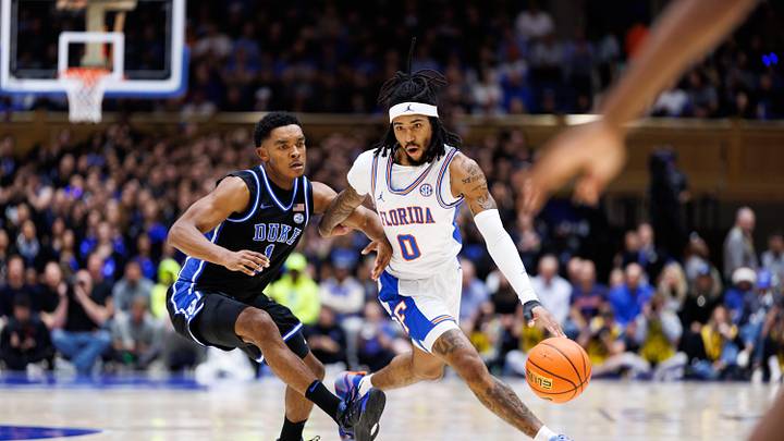 Florida Gators guard Boogie Fland (0) drives to the basket past Duke Blue Devils guard Caleb Foster (1) during the first half at Cameron Indoor Stadium in Durham, NC on Tuesday, December 2, 2025. [Matt Pendleton/Gainesville Sun]