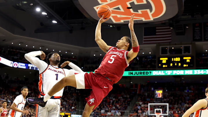 Jan 10, 2026; Auburn, Alabama, USA;  Arkansas Razorbacks guard Darius Acuff Jr. (5) gets a shot off after being fouled by Auburn Tigers guard Kevin Overton (1) during the first half at Neville Arena. Mandatory Credit: John Reed-Imagn Images
