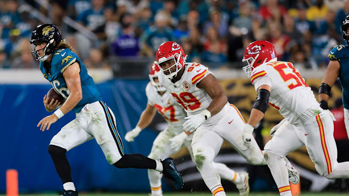 Jacksonville Jaguars quarterback Trevor Lawrence (16) rushes for yards against Kansas City Chiefs defensive tackle Jerry Tillery (99) and defensive end George Karlaftis (56) during the second quarter of an NFL football matchup at EverBank Stadium, Monday, Oct. 6, 2025, in Jacksonville, Fla. [Corey Perrine/Florida Times-Union]