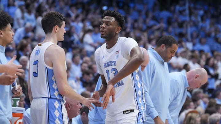Mar 5, 2024; Chapel Hill, North Carolina, USA; North Carolina Tar Heels forward Jalen Washington (13) comes off the court greeted by guard Cormac Ryan (3) during the second half at Dean E. Smith Center. Mandatory Credit: Jim Dedmon-USA TODAY Sports