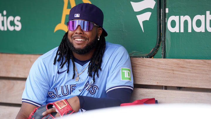 Jun 8, 2024; Oakland, California, USA; Toronto Blue Jays first baseman Vladimir Guerrero Jr. (27) smiles in the dugout before the start of the game against the Oakland Athletics at Oakland-Alameda County Coliseum. Mandatory Credit: Cary Edmondson-USA TODAY Sports