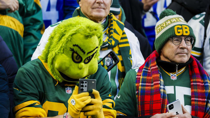 Dec 15, 2024; Seattle, Washington, USA; A Green Bay Packers fan wearing a Grinch mask watches pregame warmups against the Seattle Seahawks at Lumen Field. Mandatory Credit: Joe Nicholson-Imagn Images