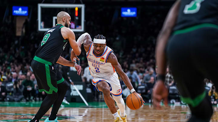 Mar 12, 2025; Boston, Massachusetts, USA; Oklahoma City Thunder guard Shai Gilgeous-Alexander (2) drives the ball against Boston Celtics guard Derrick White (9) in the third quarter at TD Garden. Mandatory Credit: David Butler II-Imagn Images