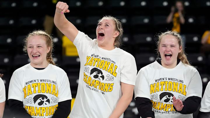 Iowa’s Macey Kilty, Kylie Welker and Jaycee Foeller celebrate after the team’s first-place finish at NCWWC’s Saturday, March 8, 2025 at Xtream Arena in Coralville, Iowa.