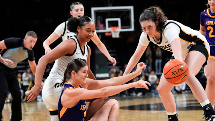 Ashland forward Katelyn Harabedian (7) passes the ball as Iowa forward Hannah Stuelke (45) and Iowa center Ava Heiden (5) defend Oct. 30, 2025 during an exhibition game at Carver-Hawkeye Arena in Iowa City, Iowa. Ashland forward Katelyn Harabedian (7) passes the ball as Iowa forward Hannah Stuelke (45) and Iowa center Ava Heiden (5) defend Oct. 30, 2025 during an exhibition game at Carver-Hawkeye Arena in Iowa City, Iowa.