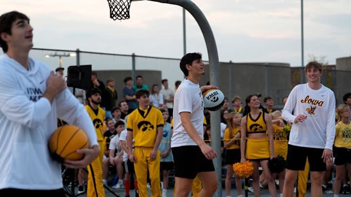 Iowa men’s basketball players watch trick shot attempts during the Hawkeye Hoops from Downtown event Oct. 17, 2025 on the University of Iowa campus in Iowa City, Iowa.