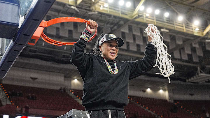 March 9, 2025; Greenville, SC, USA;  South Carolina Gamecocks head coach Dawn Staley cuts the net down  after the win over Texas in the SEC womenís championship  at Bon Secours Wellness Arena. Mandatory Credit: Jim Dedmon-Imagn Images
