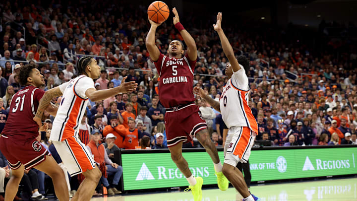 Jan 17, 2026; Auburn, Alabama, USA; South Carolina Gamecocks guard Meechie Johnson (5) takes a shot between Auburn Tigers guard Tahaad Pettiford (0) and guard Elyjah Freeman (6) during the first half at Neville Arena. Mandatory Credit: John Reed-Imagn Images