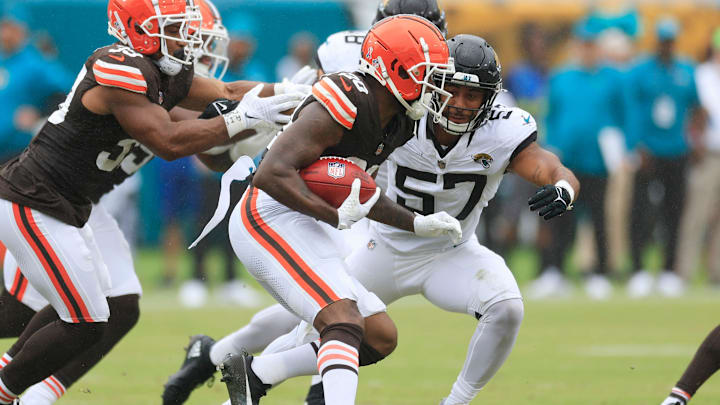 Cleveland Browns running back Pierre Strong Jr. (20) rushes for yards as Jacksonville Jaguars linebacker Caleb Johnson (57) makes the tackle during the second quarter of an NFL football matchup Sunday, Sept. 15, 2024 at EverBank Stadium in Jacksonville, Fla. The Browns defeated the Jaguars 18-13. [Corey Perrine/Florida Times-Union]