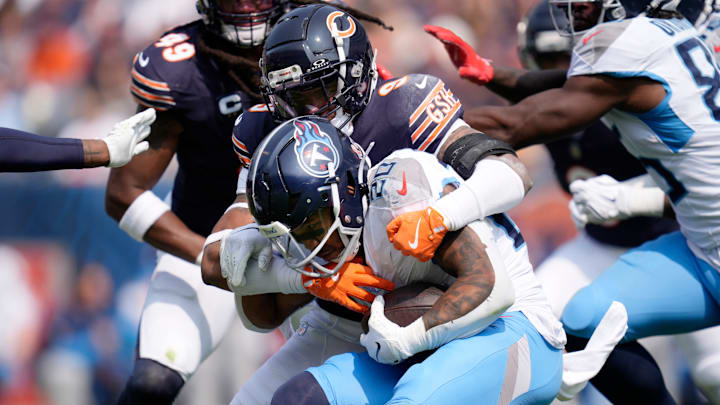 Tennessee Titans running back Tony Pollard (20) is wrapped up by Chicago Bears safety Jaquan Brisker (9) during the third quarter at Soldier Field in Chicago, Ill., Sunday, Sept. 8, 2024.