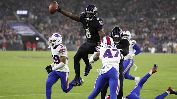 Sep 29, 2024; Baltimore, Maryland, USA; Baltimore Ravens quarterback Lamar Jackson (8) leaps across the goal line for a touchdown as Buffalo Bills cornerback Christian Benford (47) and Bills cornerback Cam Lewis (39) defend at M&T Bank Stadium. Mandatory Credit: Geoff Burke-Imagn Images
