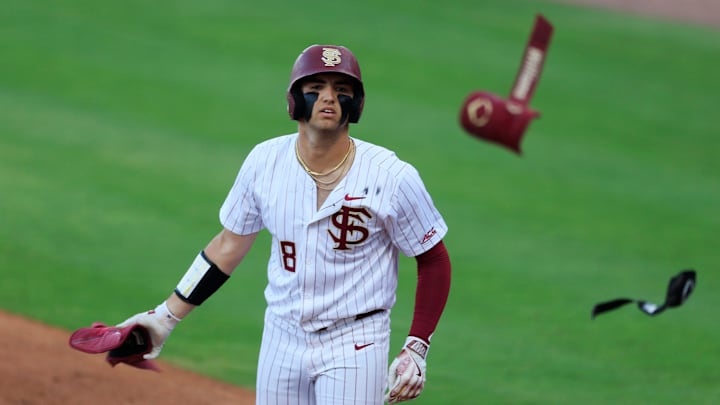Florida St. outfielder Max Williams (18) tosses his batting guards before taking first base during the first inning of an NCAA college baseball matchup Tuesday, March 25, 2025 at VyStar Ballpark in Jacksonville, Fla. FSU rallied to defeat UF 8-4 off a walk-off grand slam from Alex Lodise in the ninth inning. [Corey Perrine/Florida Times-Union]