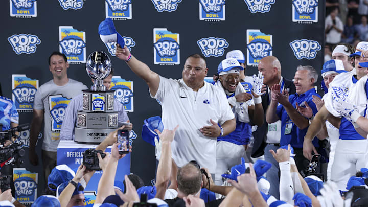 Dec 27, 2025; Orlando, FL, USA; BYU Cougars head coach Kalani Sitake celebrates after beating Georgia Tech Yellow Jackets in the Pop-Tarts Bowl at Camping World Stadium. Mandatory Credit: Nathan Ray Seebeck-Imagn Images