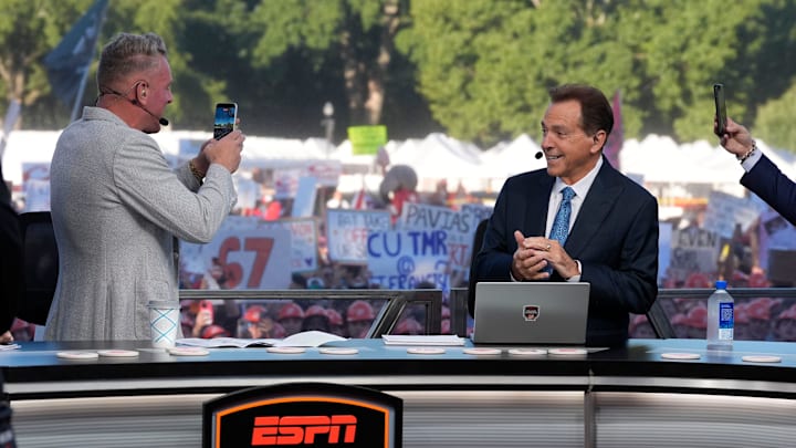 Oct. 4, 2025; Tuscaloosa, Alabama, USA; Pat McAfee takes a cell phone video of former Alabama head coach Nick Saban, now a co-host of the ESPN College GameDay show, as he comes on set on location on the Quad at the University of Alabama before the Alabama versus Vanderbilt game.